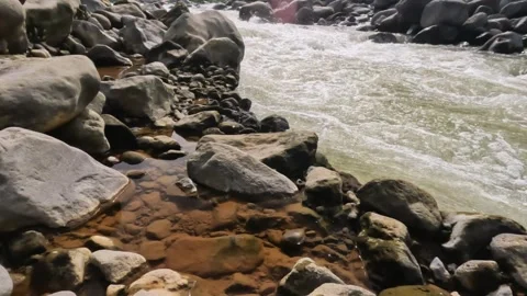 Slow motion waves on the river bank in the rocky mountains Video stock 320978141