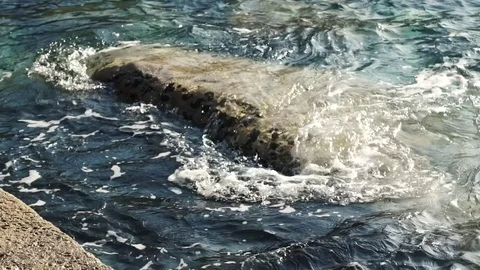 Slow motion of waves on the rocks by the shore in a Mediterranean sea, H Stock Footage 75506129
