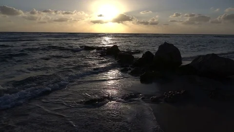 Slow Motion Waves on Rocky Beach and Brilliant Sunset Above Видео 78211464