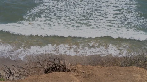 Slow motion waves roll in coast cliff perspective Stock Footage 112640437