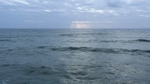 Slow-motion waves roll as sun sets over vast peaceful ocean Stock Footage 112703242