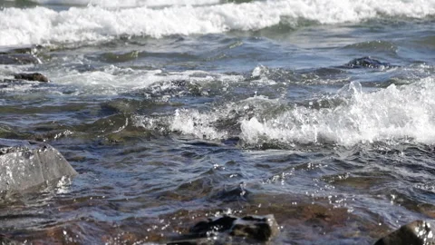 Slow motion waves rolling into rocky shore, Lake Superior, Duluth, Minnesot.. Stock Footage 307951953