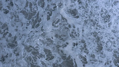 Slow-motion waves rolls through churning whitewater, top-down aerial  Stock Footage 112705900