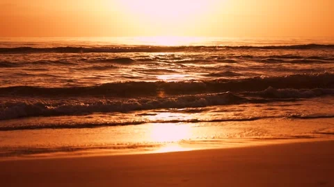 Slow motion waves on the sand at the beach during beautiful golden sunrise . The 스톡 동영상 243272824