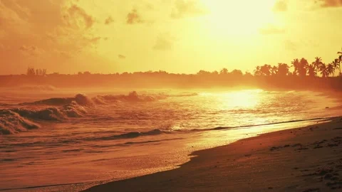 Slow motion of waves on the sand of tropical beach at golden sunset. Beautiful Stock Footage 226973903