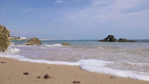 Slow motion waves on sandy beach Video stock 130870725