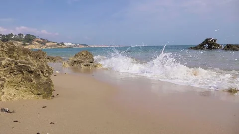 Slow motion waves on a sandy beach Stock Footage 130870899