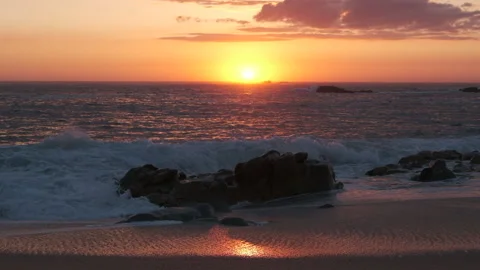 Slow motion waves splashing into the air at sunset on beach Stock Footage 130420801