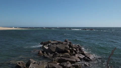 Slow motion waves splashing over rocks in ocean wide angle 動画素材 132210155