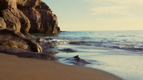 Slow Motion. Waves Splashing Over Rocks On Sandy Beach Shoreline Video stock 327712037