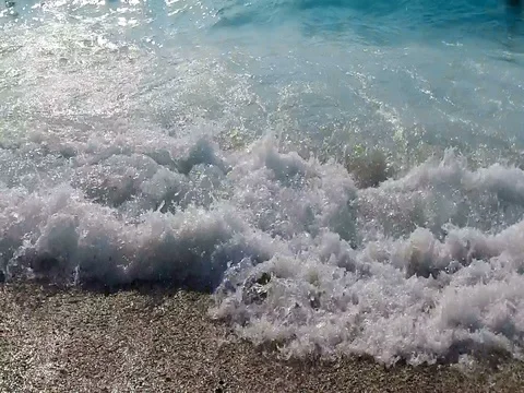 Slow motion of the waves splashing on the shore and transparent turquoise sea Stock Footage 80064113
