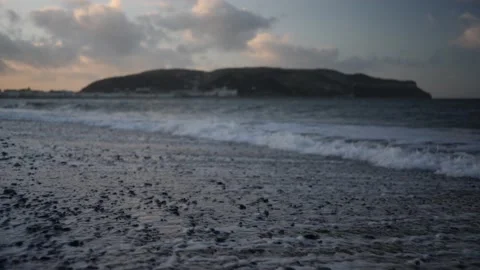 Slow motion waves on stoney beach at magic hour, LLandudno. Video stock 150290288