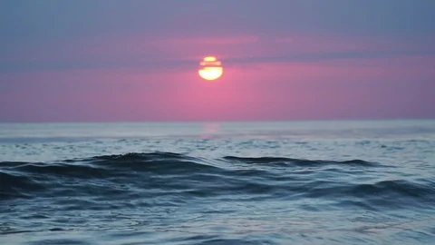 Slow-motion of waves with the sunrise background. Stock Footage 122161727