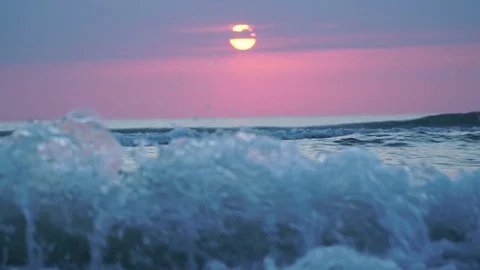 Slow-motion of waves with the sunrise background. Stock Footage 123360530
