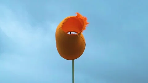 Slow Motion Waving Orange Wind Sock in Cloudy Day, Stock Footage 156397827