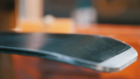 Slow motion of wax dripping onto base of ski Stock Footage 94193088