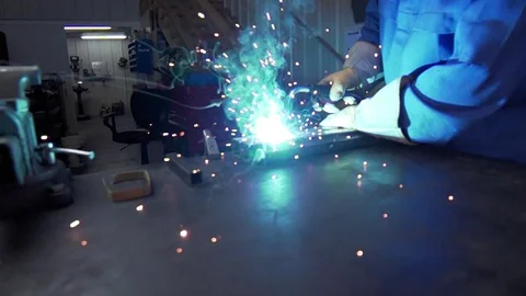 Slow Motion welding in dark workshop with sparks flying Stock Footage 73153842