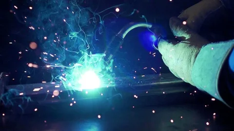 Slow Motion welding in dark workshop with sparks flying Stock Footage 73153860
