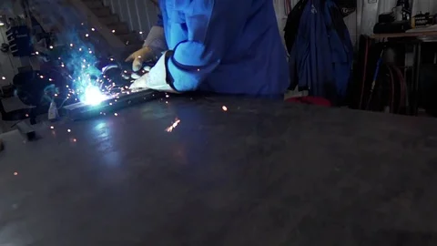Slow Motion welding in dark workshop with sparks flying Stock Footage 73153980
