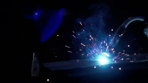 Slow Motion welding in dark workshop with sparks flying Stock Footage 73154189