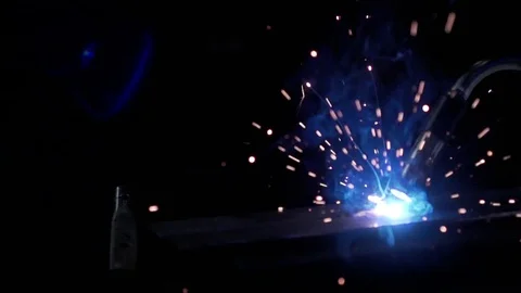 Slow Motion welding in dark workshop with sparks flying Stock Footage 73154209