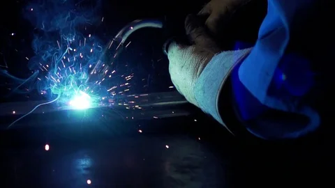 Slow Motion welding in dark workshop with sparks flying Stock Footage 73154252