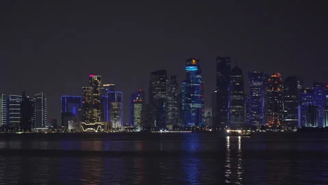 Slow motion of West Bay illuminated skyscrapers and traditional dhow boat. Stock Footage 339323443