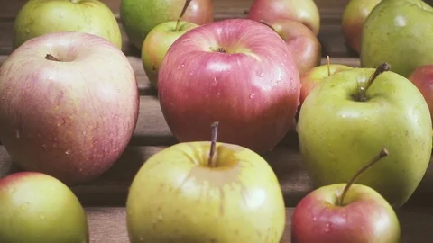 Slow motion wet apples of different sizes on the table Stock Footage 88096588