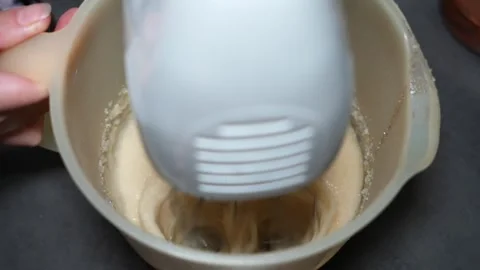Slow Motion Whipping Eggs and Sugar with Hand Mixer Video stock 320393581