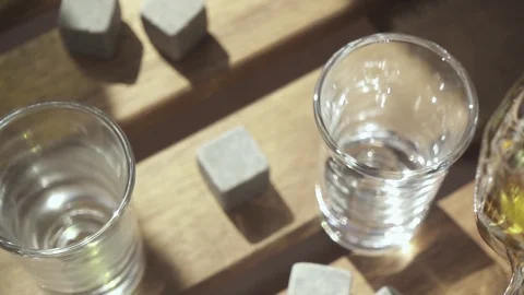 Slow motion whiskey flows from the decanter into the glass Stock Footage 88916789