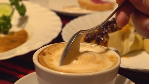 Slow motion. white cup of coffee with thick foam. cappuccino. the man stirs Stock Footage 81970566