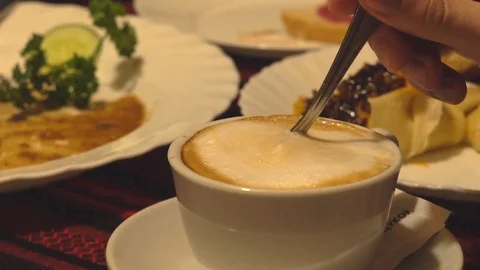 Slow motion. white cup of coffee with thick foam. cappuccino. the man stirs Stock Footage 81970987