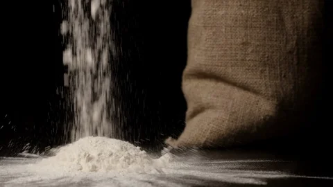 SLOW MOTION: White flour falling down near a sac Stock Footage 91173142