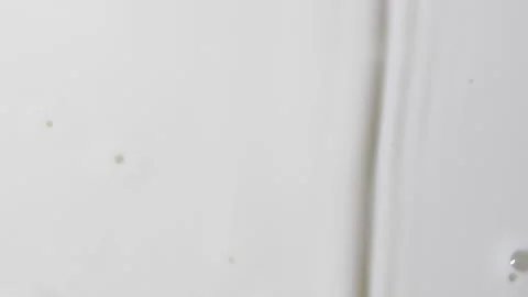 Slow motion white liquid cream ripples, close-up fresh milk drink splash texture Stock Footage 212517066