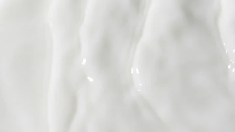 Slow motion white liquid cream ripples, close-up fresh milk drink splash texture Video stock 234484937