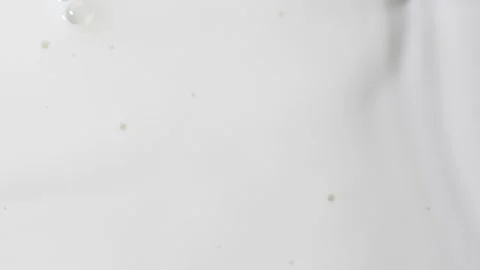 Slow motion white liquid cream ripples, close-up fresh milk drink splash texture 動画素材 246842675