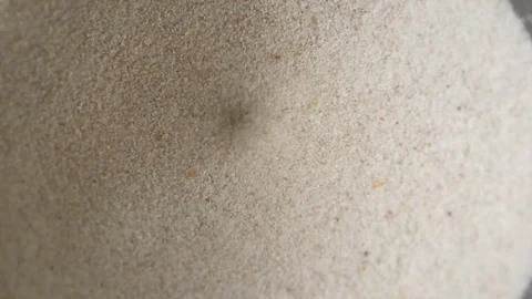 Slow motion, white sand flowing in hole Stock Footage 109520472