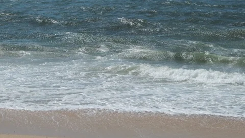 Slow motion white surf waves breaking on sandy beach in summer Stock Footage 115787587