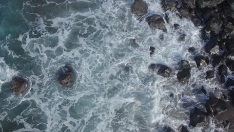 Slow Motion White Waves Crashing on Dark Basalt Volcanic Rocks Stock Footage 327635602