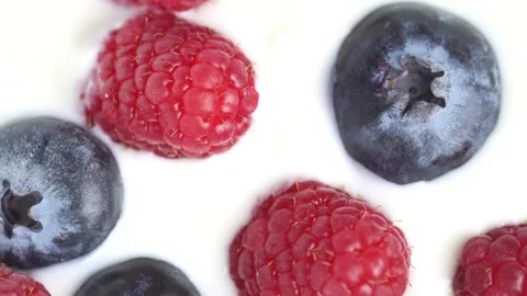 Slow motion of white yogurt with raspberry and blueberry, top view, rotatio.. Stock Footage 268272703