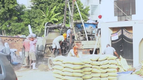 Slow motion wide angle shot of construction site with underprivileged laborers Stock Footage 142158251