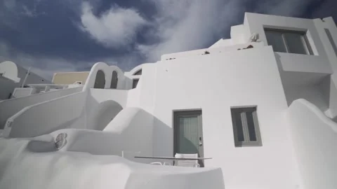 Slow motion wide shot of the icon whitewashed houses of Santorini Stock Footage 257685960