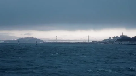 Slow motion wide shot a ship sailing in front of San Francisco skyline and Stock Footage 135798409