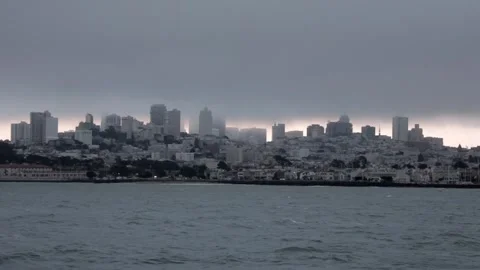 Slow motion wide shot a ship sailing in front of San Francisco skyline and Stock Footage 135798412