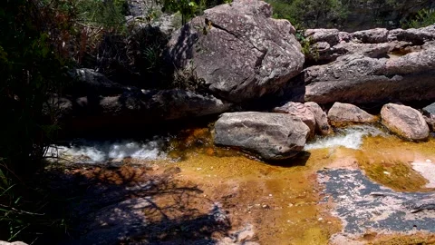 Slow motion wide shot of a stream flowing along rocks , Brazil. Stock Footage 237477661