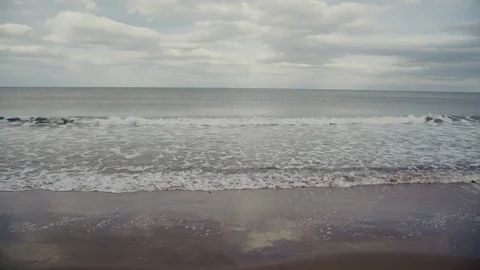 Slow motion wide of waves crashing on to the beech Video stock 87660735