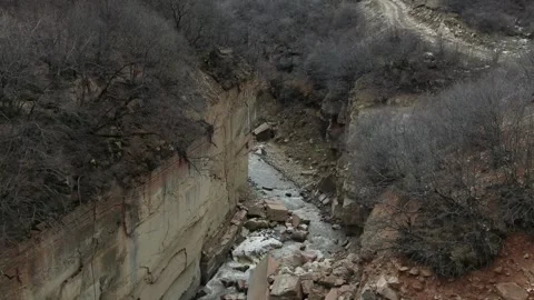 Slow Motion Wild Grey River flows between Rocky Shores of Mountain Stones 6 Stock Footage 239858725