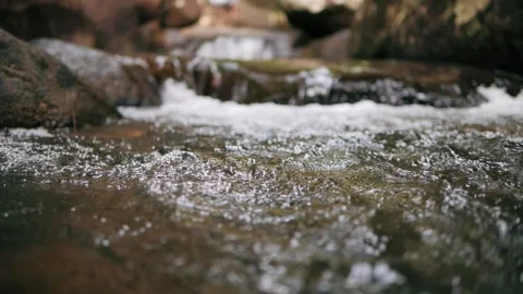Slow motion of wild mountain river abundant clear stream flowing through rocks 스톡 동영상 149045821