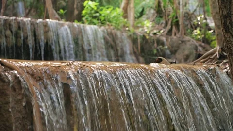 Slow motion of wild mountain waterfall abundant clear stream flowing Stock-Footage 169558112