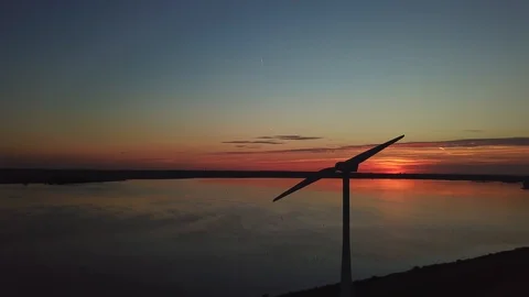Slow motion wind turbine with a nice sunset Stock Footage 95937552